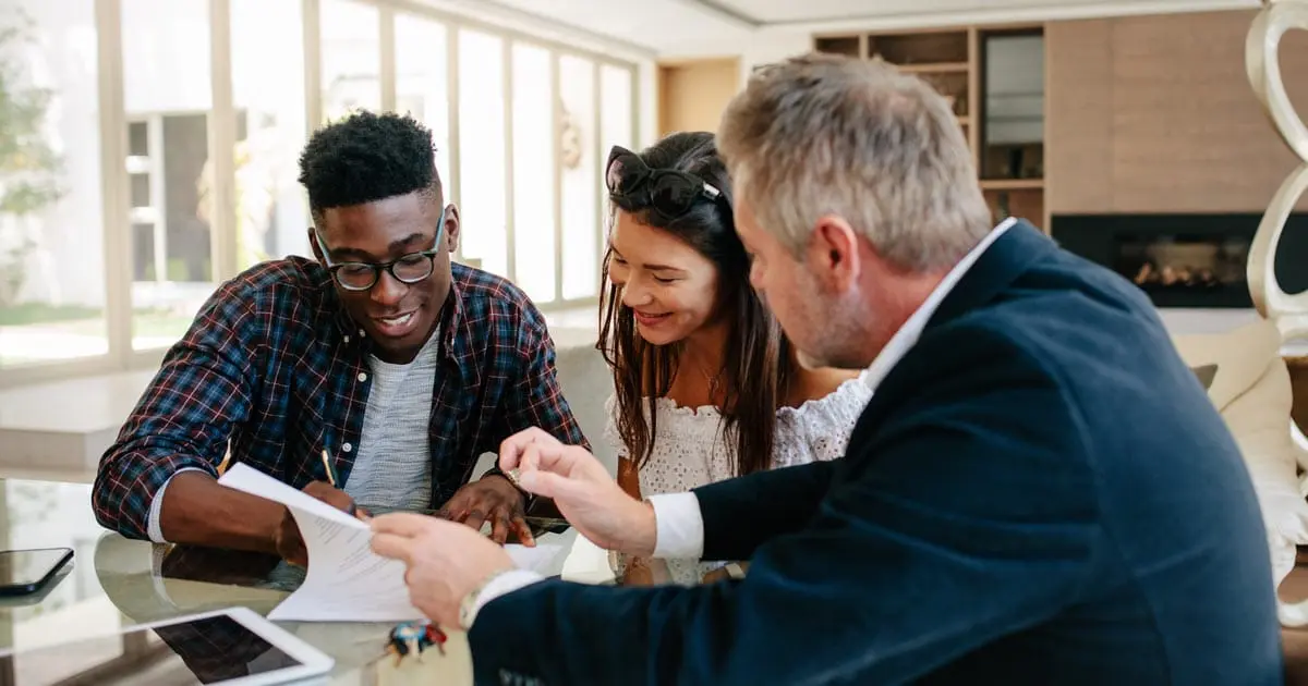 couple working with realtor to buy home