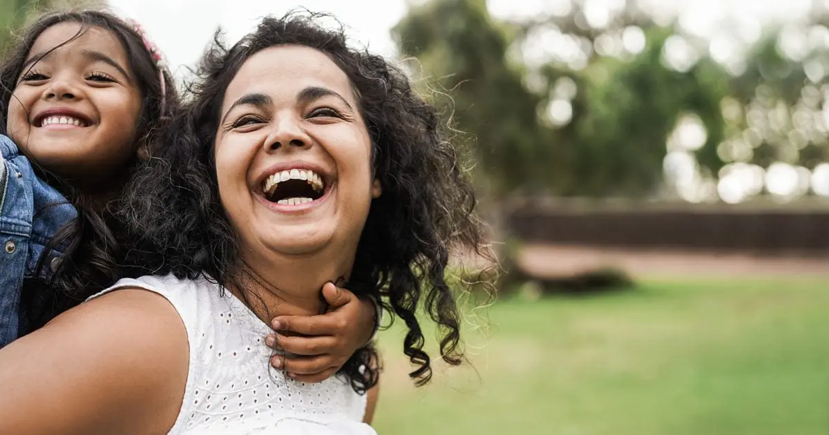 mom and daughter smiling
